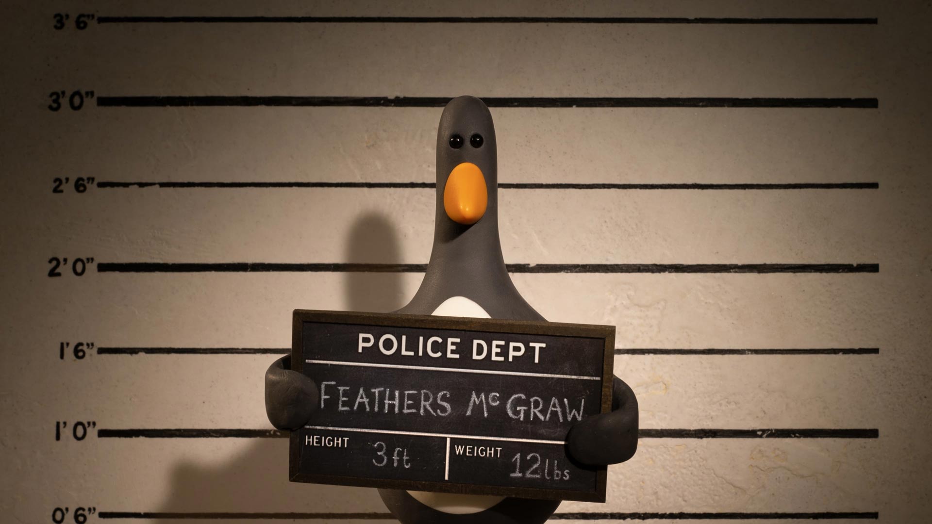 Feathers McGraw getting a mugshot taken in Wallace & Gromit: Vengeance Most Fowl