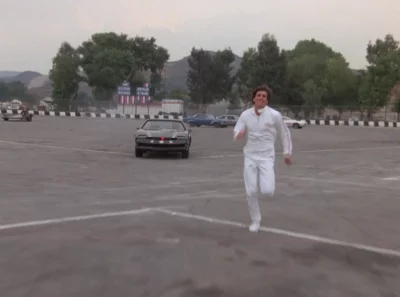 A man running away from KITT in Knight Rider: Slammin' Sammy's Stunt Show Spectacular