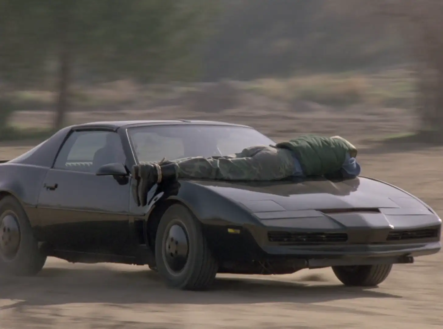 A man strapped to KITT's hood in Knight Rider: Hearts of Stone